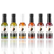 Unleash your inner daredevil with our six original hot sauces. Free shipping if you try all six. Each sauce features a unique mix of peppers and spices. From medium to extra hot, these bold blends will add flavor to any dish!  From peppers such as Serrano, Peri-Peri, and different flavors such as tropical and smoky, each bottle creates its own unique flavor. We hope Revved Up makes you feel inspired to take more risks and spice up your life! White background. 