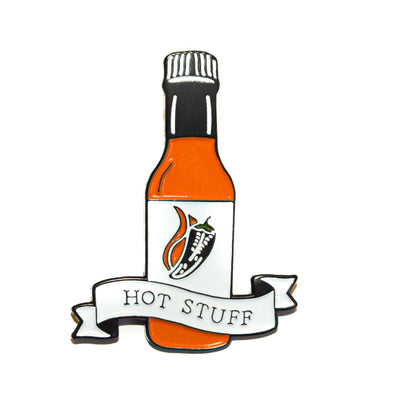 Hot Stuff soft enamel pin with white background. This hot sauce pin is a spicy way to show off your favorite condiment. Available exclusively here at Revved Up!
