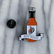 Hot Stuff soft enamel pin front and back with marble background. This hot sauce pin is a spicy way to show off your favorite condiment. Available exclusively here at Revved Up!