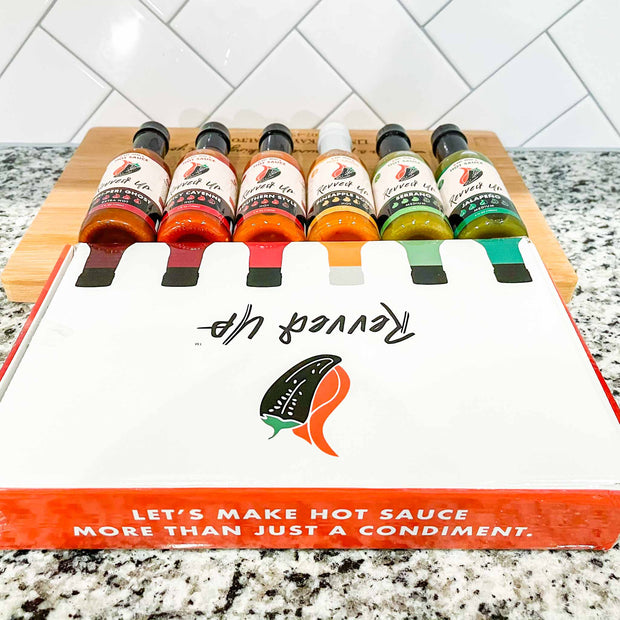 Unleash your inner daredevil with our six original hot sauces. All six. Jalapeno hot sauce. Serrano hot sauce. Pineapple Bomb hot sauce. Southern Style hot sauce. Spicy cayenne hot sauce. Peri peri ghost. Free shipping. . All six sauces are sitting next to the custom Revved Up box that say&